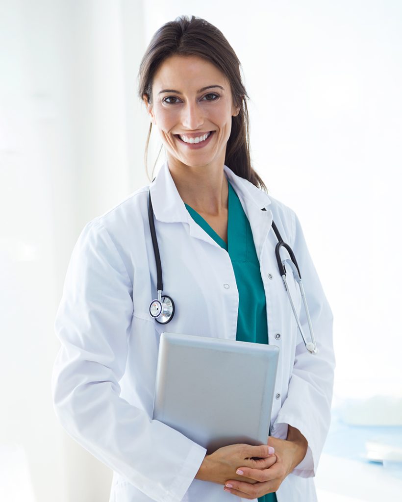 Portrait of beautiful young female doctor looking at camera in the office.